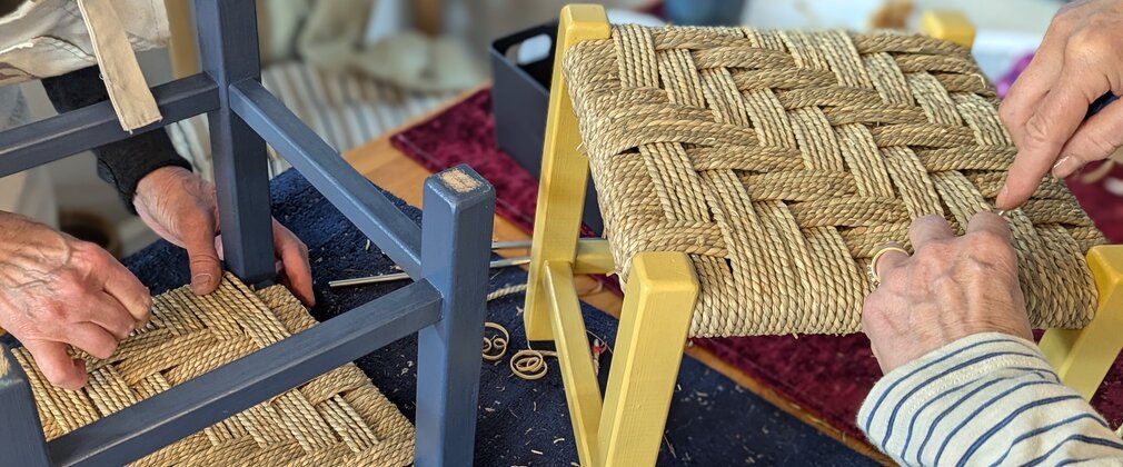 Beech wood and seagrass footstool weaving workshop, hands are seen weaving the footstall together.