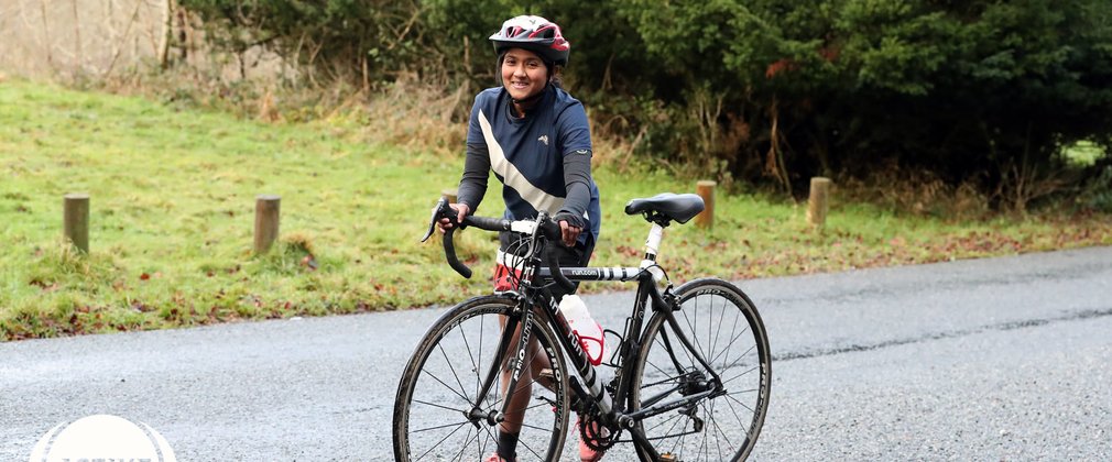 Duathlon participant walks with bike at Wendover Woods