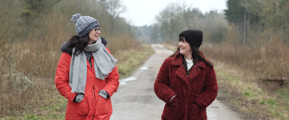Two friends walking on a path