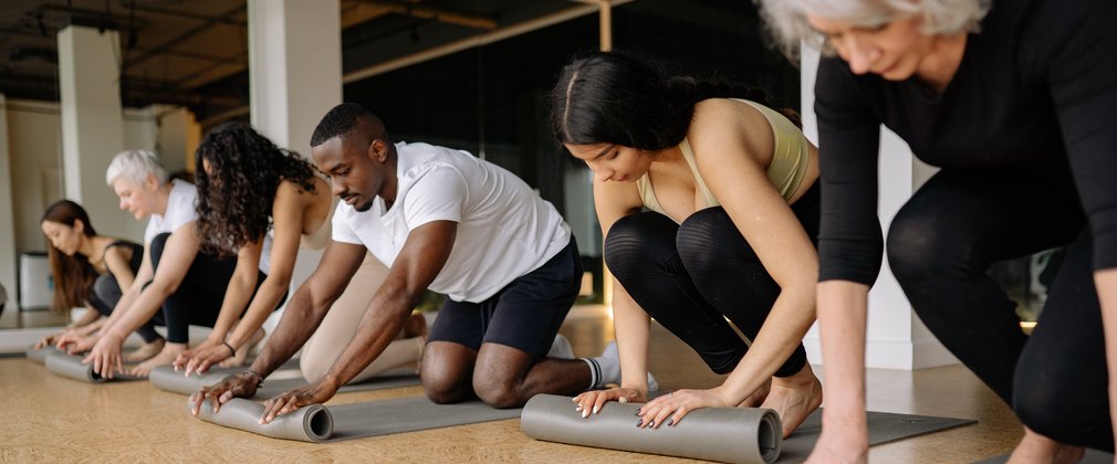 Fit4Life pilates group of people rolling up yoga mats
