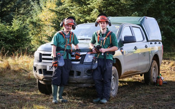 Foresters beside vehicle