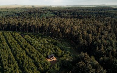 A drone image of an Unyoked cabin in Dalby Forest