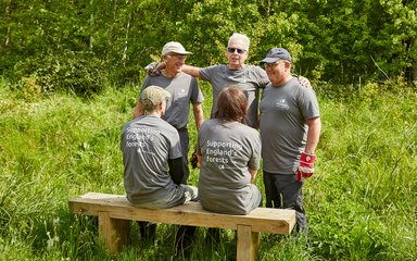 Volunteering group sat on a bench 