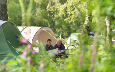 Couple on a picnic bench in a campsite