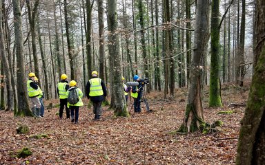 Camera crew filming in the forest
