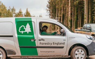 Staff sitting in a Forestry England branded van