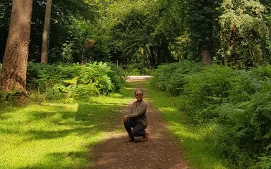 Zakiya Mckenzie crouched on forest floor