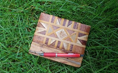 Notebook and pen on green grass