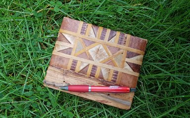 Notebook and pen on green grass