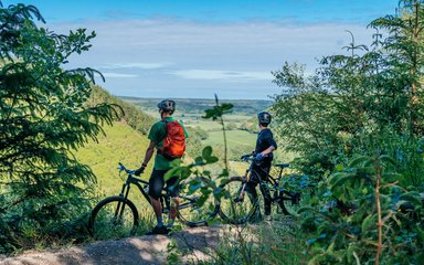 two cyclists admiring the view of an English landscape