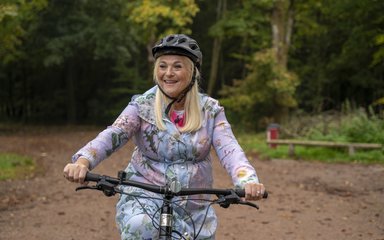 Vanessa Feltz riding a bike at Wendover Woods.