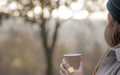 Woman holding a tea in Wendover Woods.