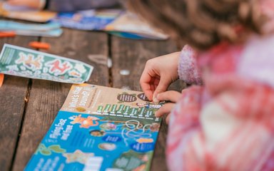 Child adding stickers to a Zog pack