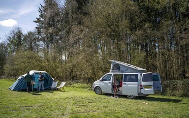 A campervan and tent at a campsite