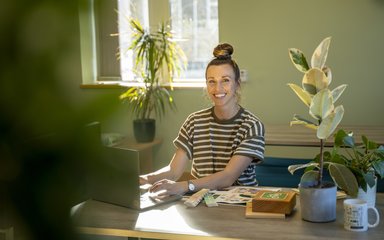 woman smiling at an office desk