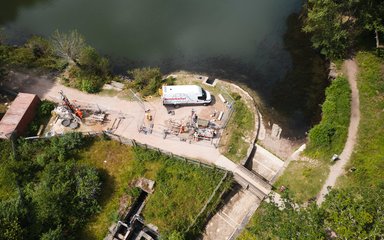 Aerial shot of a drill rig on a dam at Cannop Ponds
