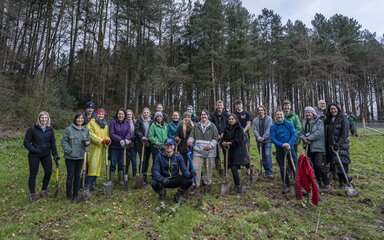 A large group of people stood in a forest