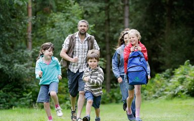 Family walking on a woodland trail