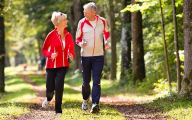 couple running through the forest 