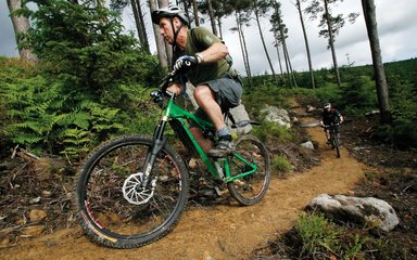 adults on mountain biking trail