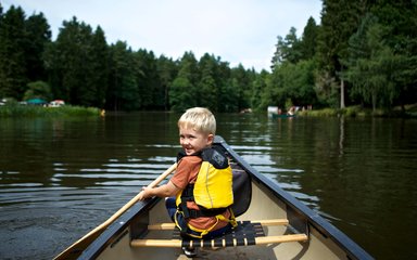 boy enjoying kayaking on the river 