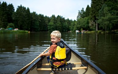 boy enjoying kayaking on the river