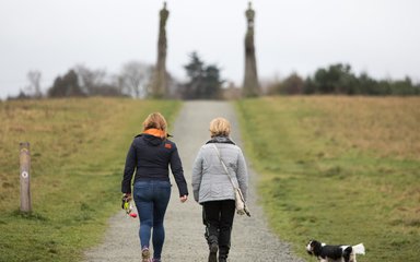 Two ladies enjoying a dog walk at Jeskyns Community Woodland 