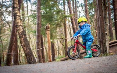 Child on balance bike in Hamsterley Forest