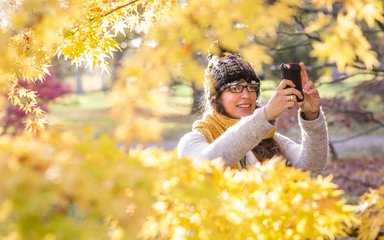 Woman using phone app in Autumn
