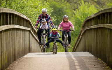 Family cycling over bride