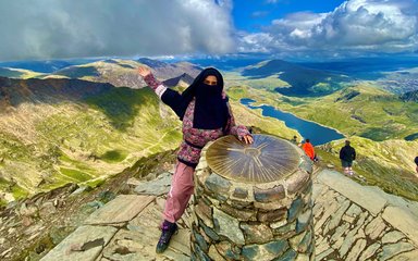 Amira poses at the top of a mountain