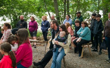 gathering of people in woodland at Festival of Archaeology 