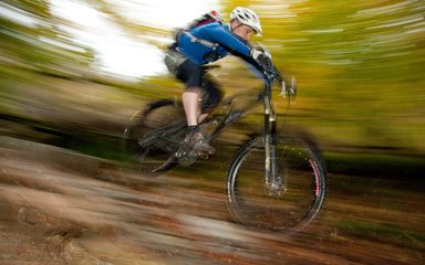 Man mountain biking at speed