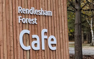 A wooden clad cafe kiosk in the forest