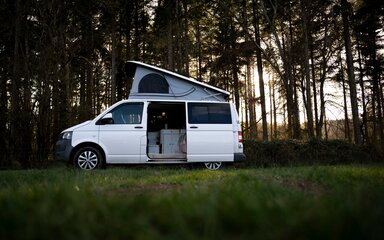 Campervan in the woods with side door open