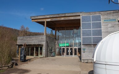 A Visitor Centre building made out of wood with a large glass frontage.