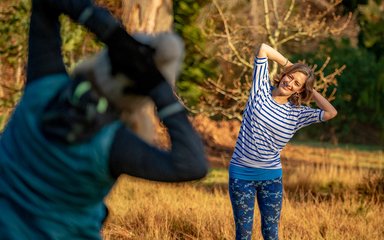 Two people doing Pilates in the forest