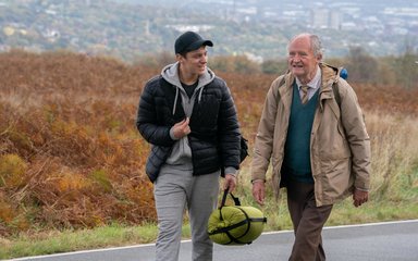 Two men walking on a country road