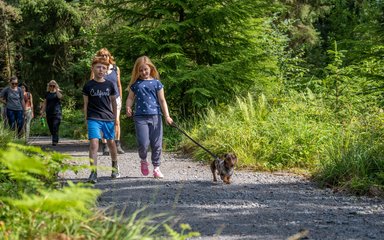 family walking with dog