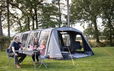 Vango Edition 60 family tent with family outside sitting around a table