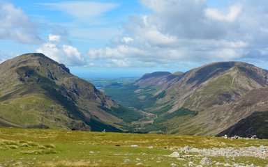 A view from a mountain looking down a wooded valley