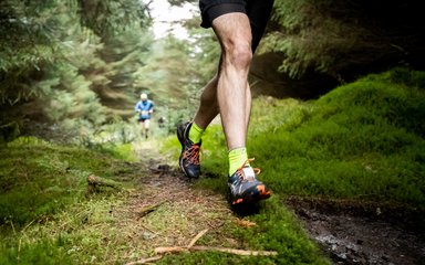 man running in forest trail