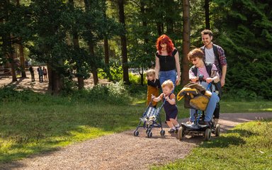 Family laughing together on an easy access trail