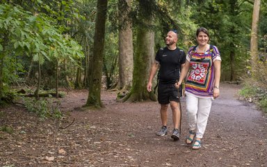 Couple walking on a forest trail