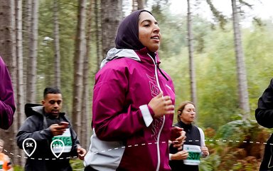 Woman in pink running at Forest Runner event