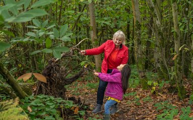 Grandma and granddaughter playing together in the forest