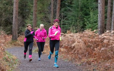 women running in forest