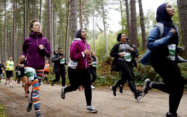 People running in Forest Runner event in a forest