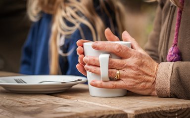 A cup of coffee at a picnic table