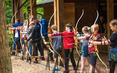 children shooting at archery